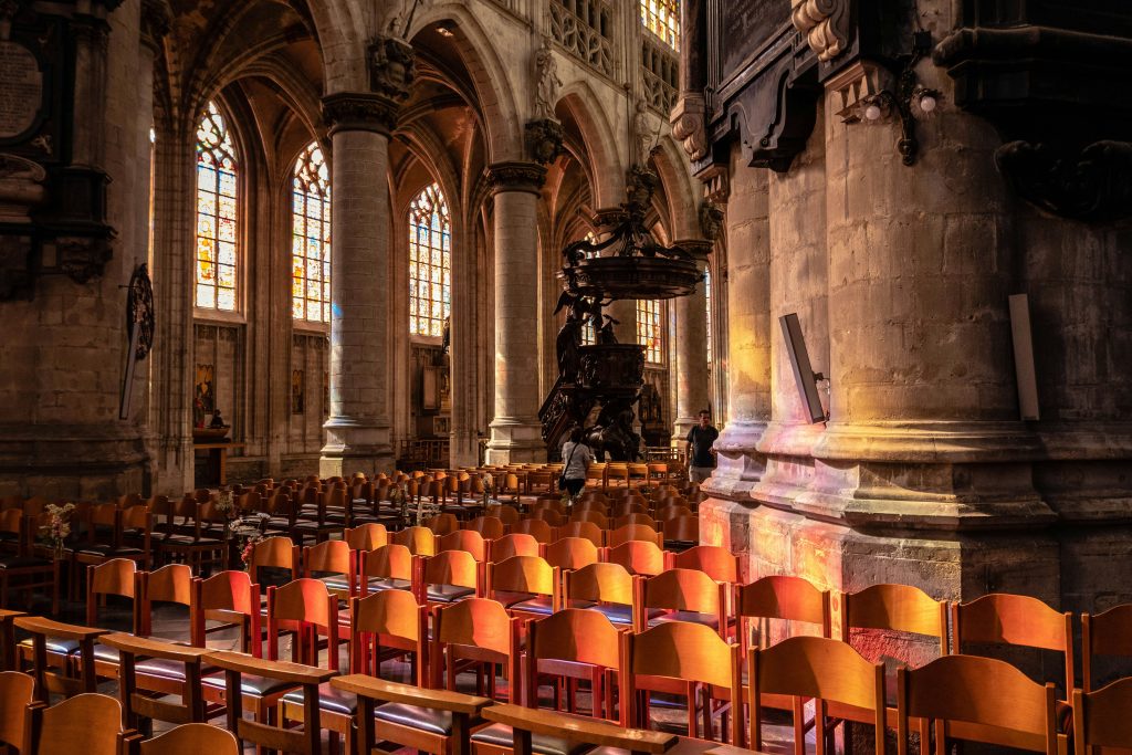 brown wooden chairs inside a cathedral
